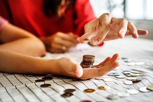 Educators Investing - pairs of hands with coins